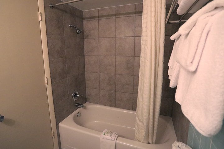 A bathroom with a bathtub and shower