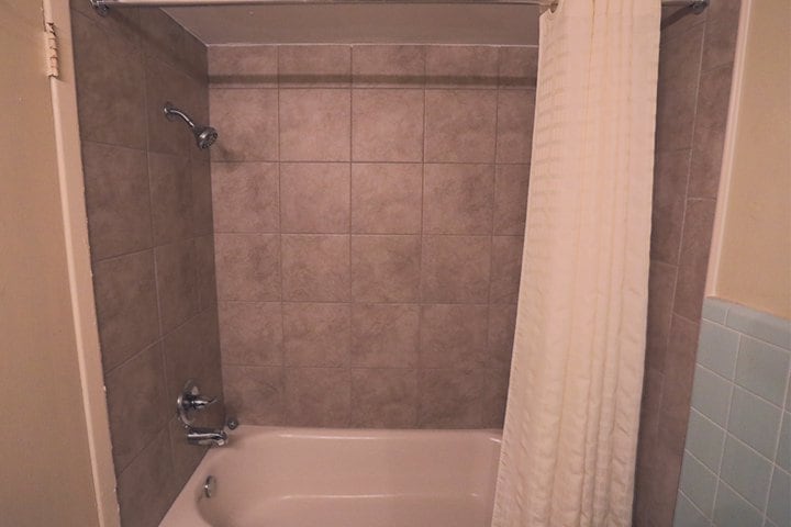 A bathroom with a tub and shower.